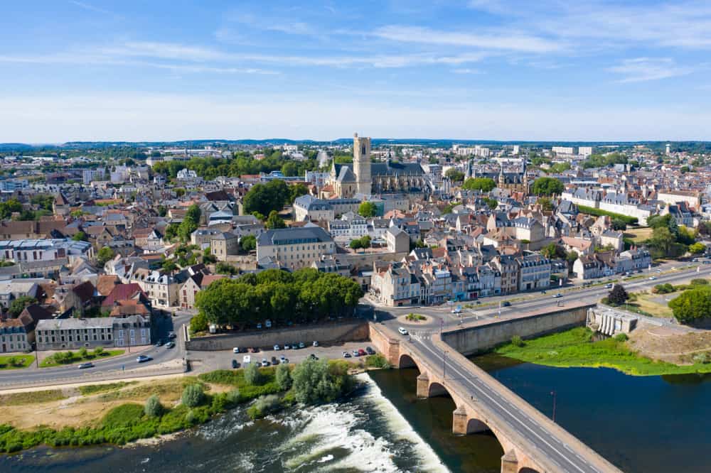 Arial view of the city of Nevers in Burgundy, France. the Loire in the foreground, the Loire bridge in stone and the city of Nevers dominated by its cathedral in the background.