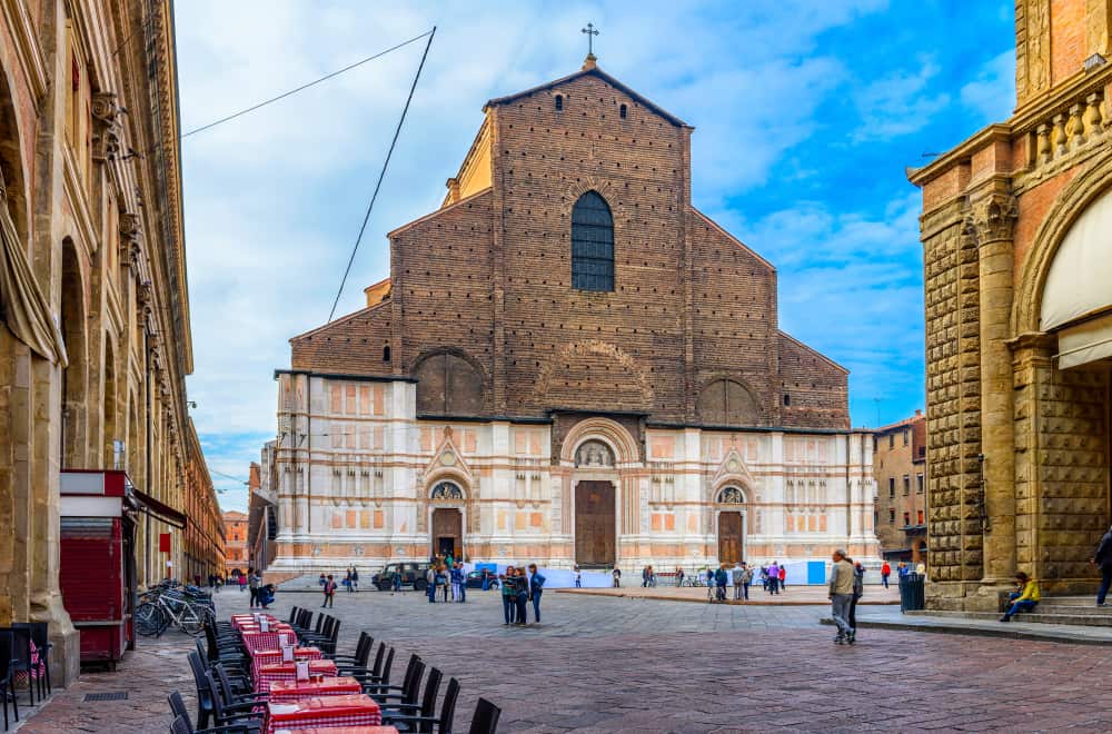 Exterior view of Basilica di San Petronio in Bologna. Pedestrians on the square.