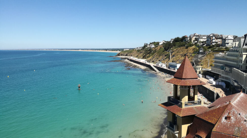 Overview of the beach and the ocean - and part of the town Granville in France.