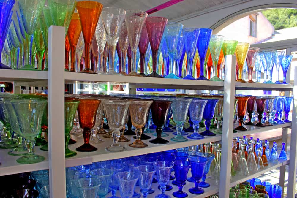 The famous colorful glasses from Biot on a shelf.