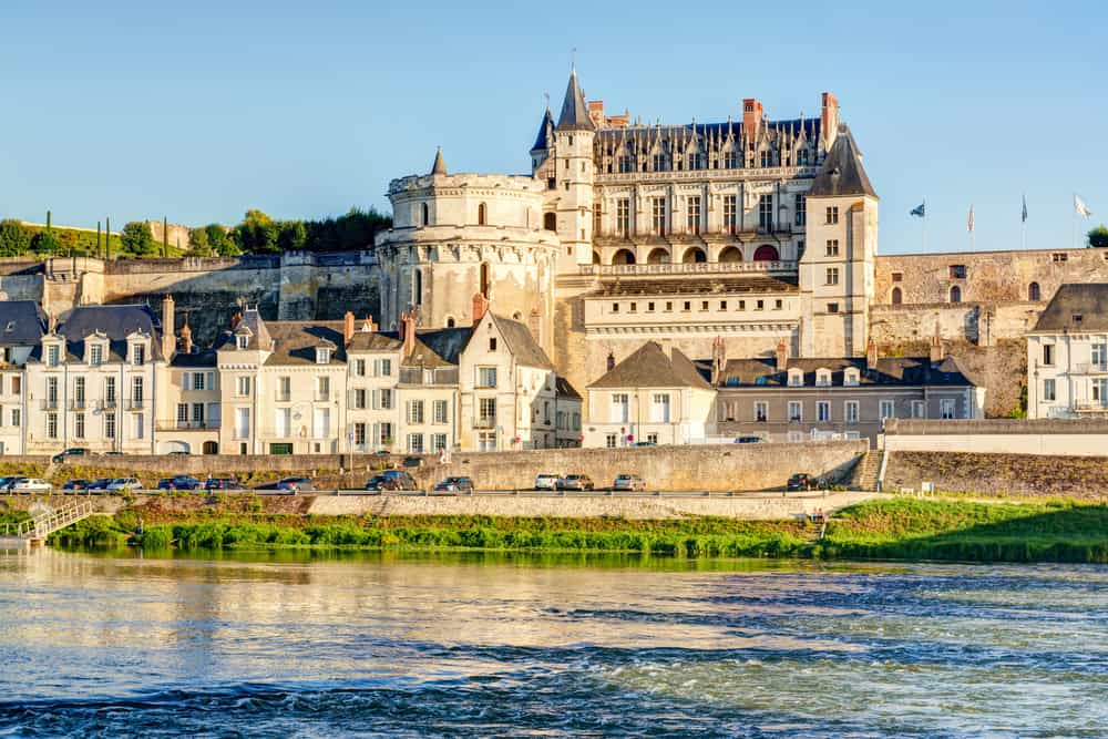 The Chateau of Amboise in France viewed from a distance with the river in front.