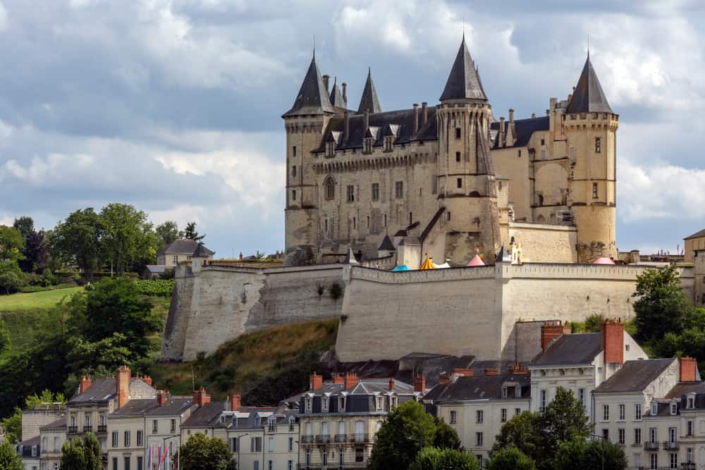 The castle of Saumur raising above the rest of the town buildings.