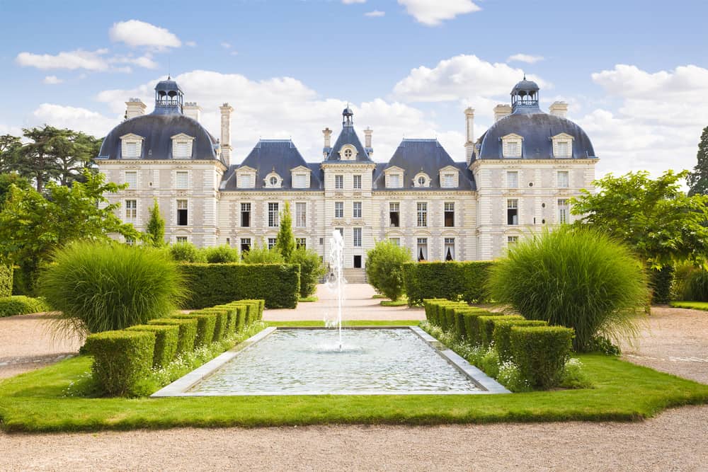 Cheverny Chateau in Loire Valley, France. The beautiful garden with fountain in front.