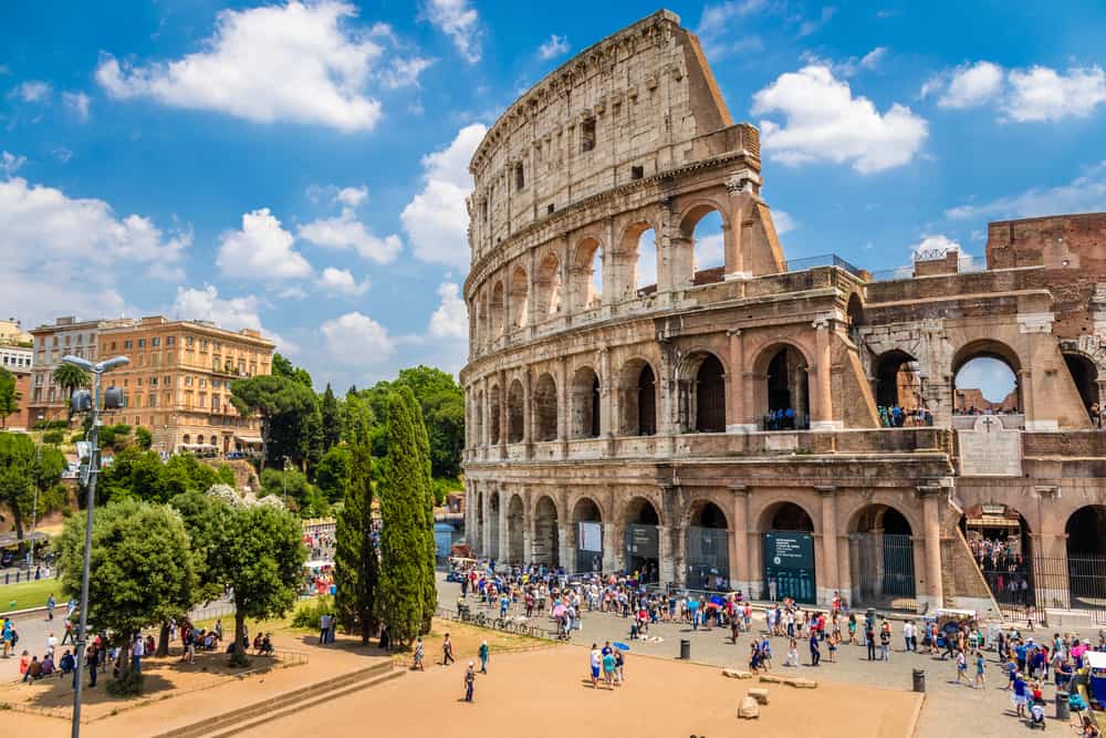 Outside of the Colosseum in Rome, Italy. Many tourist on a clear blue day.