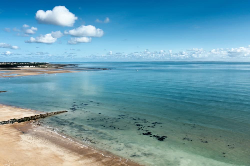 The beautiful Gautrelle beach on Ile d'Oléron in France. Clear blue sky and nice blue water next to the sandy beach.