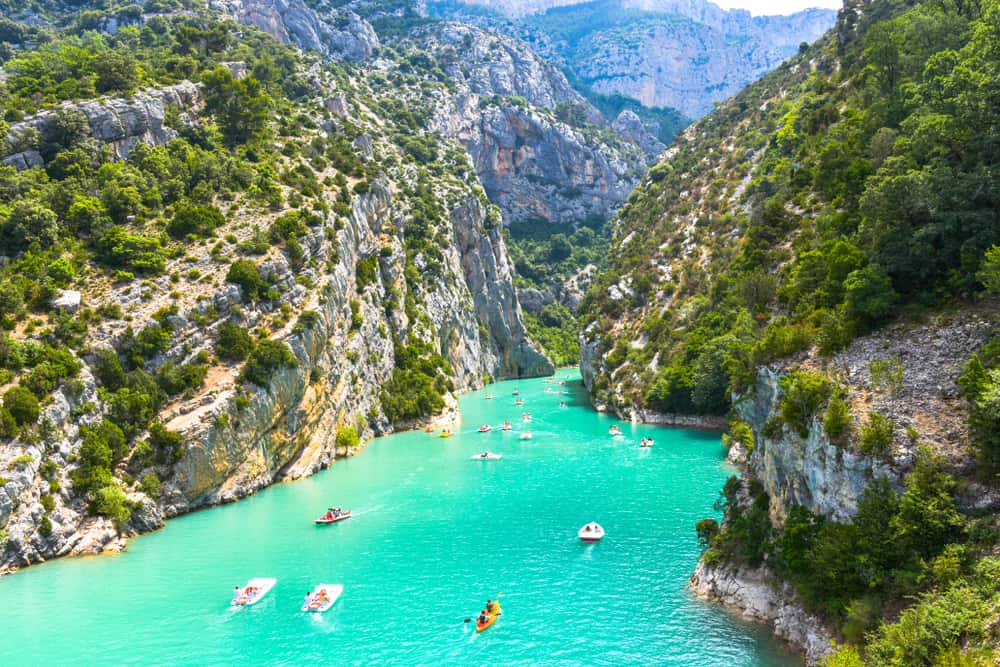 Gorges du Verdon and at the buttom the lke of Sainte-Croix and people enjoying the water.