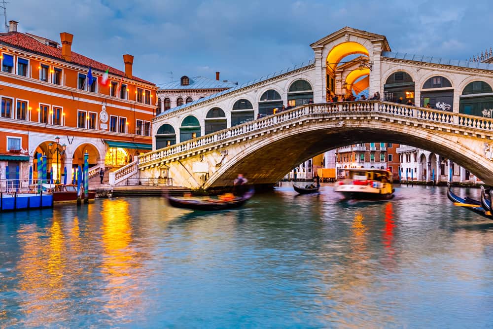The Grande Canal and the Rialto Bridge at dusk in Venice, Italy.