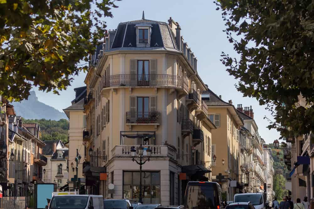 The historic center of Aix-Les-Bains in France with old building and street traffic.