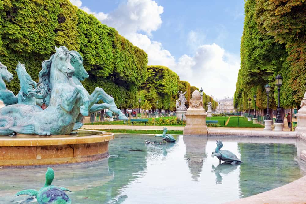 Luxemburg gardens in Paris with a fountain in front.