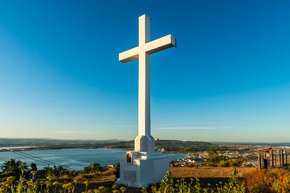 Large cross on top of Mont Saint Clair in Sète, France with a view over the lagoon.