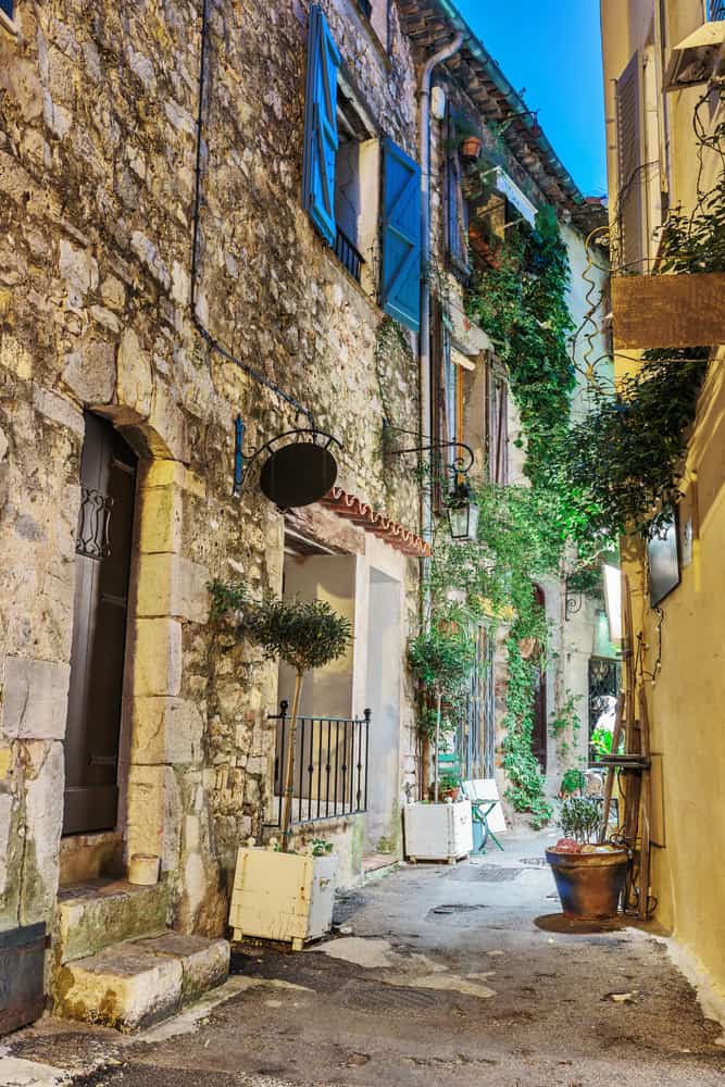 Narrow street with flowers in Mougins, France.