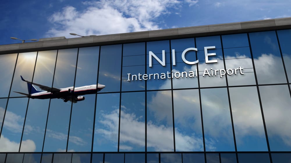 A plane reflected in the windows of Nice International Airport.