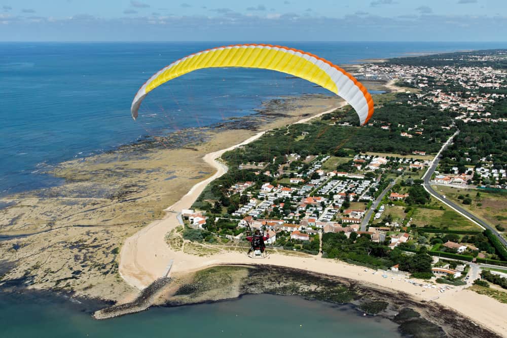 Paraglider in the air and a great view over Ile d'Oléron in France from the sky.