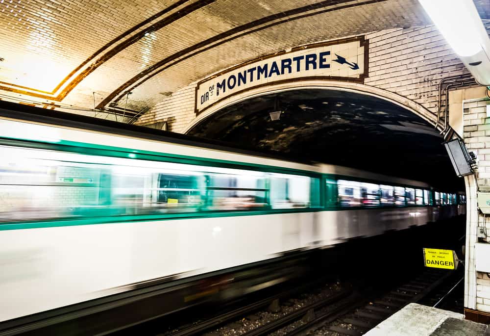 A train in the Paris underground driving in the direction of Montmartre.