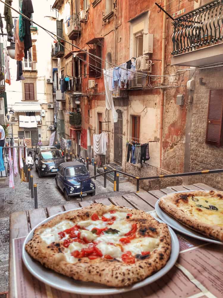 Pizza on a table of a very local street in Naples, Italy.