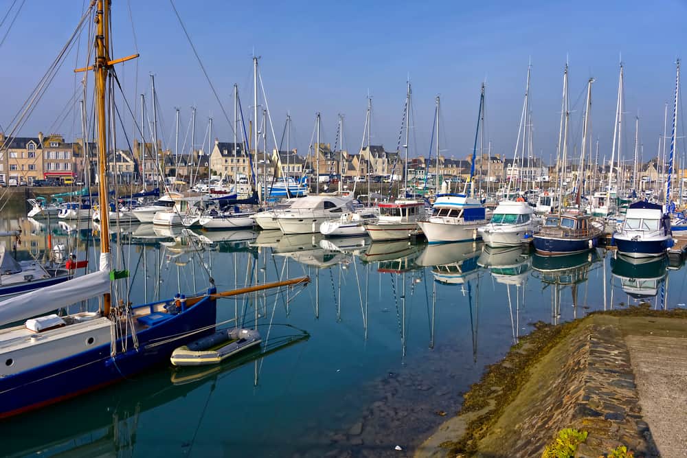 Port of Saint-Vaast-la-Hougue in the peninsula of Cotentin in Normandy, France. A port with quiet water filled with small boats.