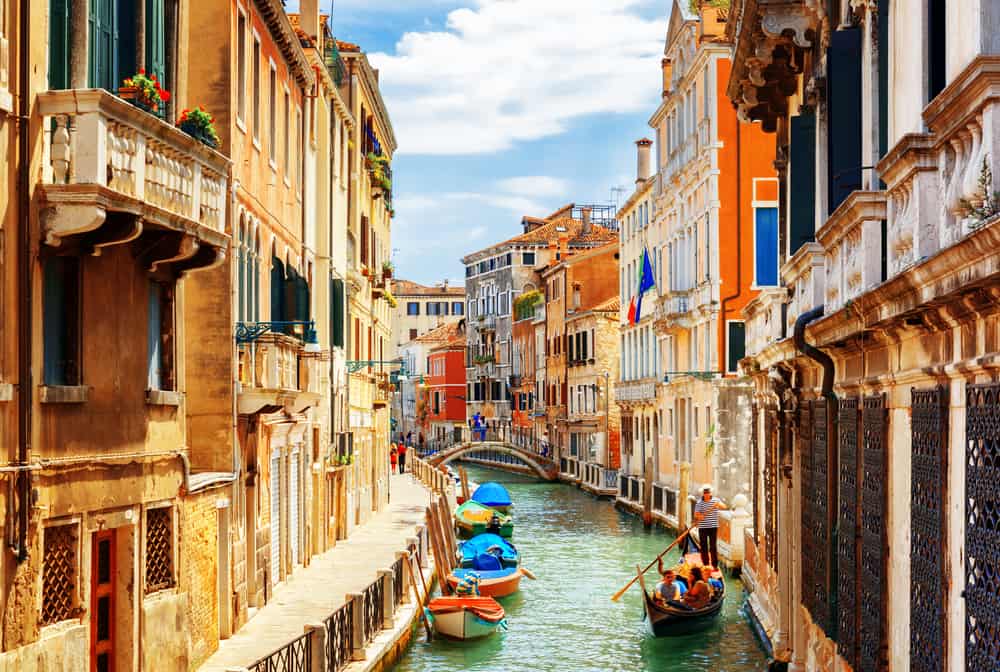 Tourist on a gondola ride on the Rio Marin canal in Venice, Italy. 