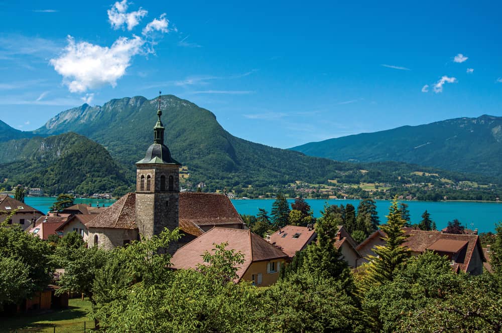 Overview of the scenic village of Talloires in France. Lake and mountains in the background.