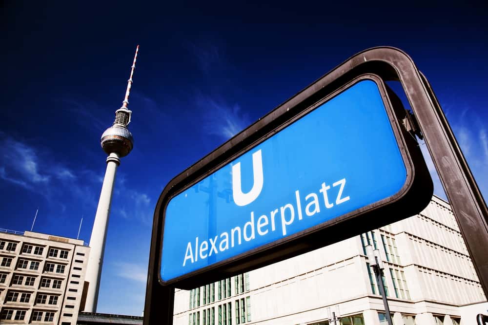 Close up of blue U-Bahn sign at Alexanderplatz in Berlin. The TV-Tower in the background.