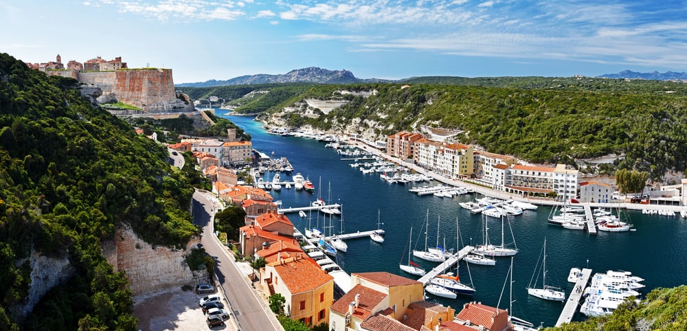 Panorama of Bonifacio city with the harbor and the Citadel at left. Corsica Island, France.