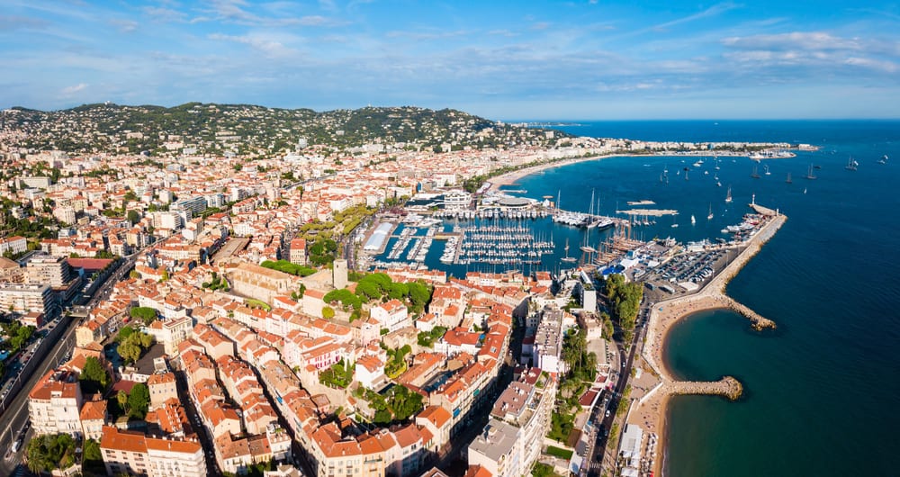 Aerial view of Cannes in France. Harbor, sea, and mountains.