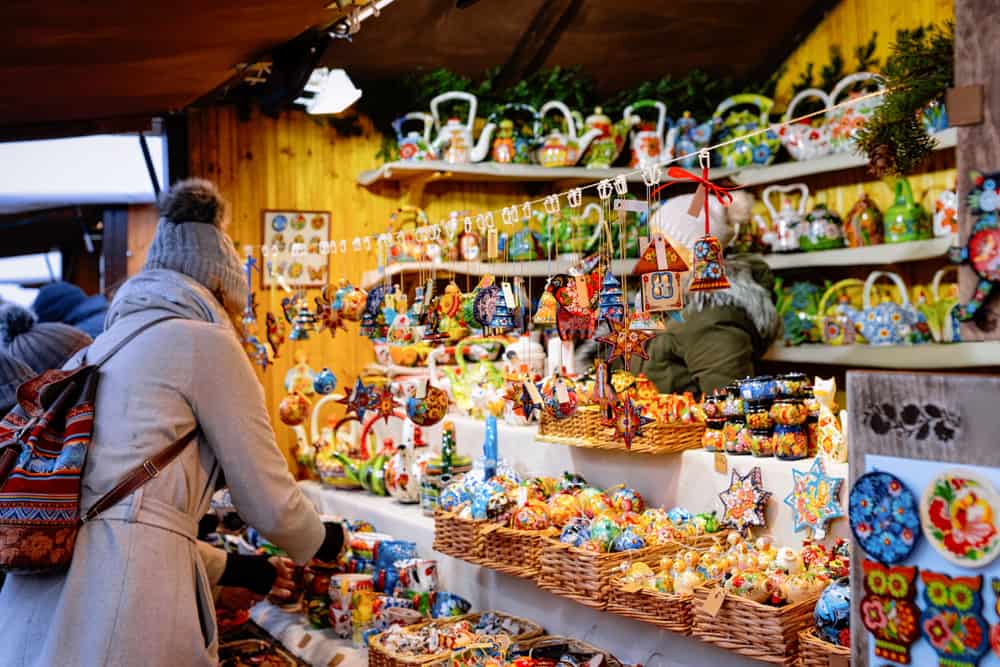 Woman shopping in a small shop at a Christmas market on Alexanderplatz, Berlin.