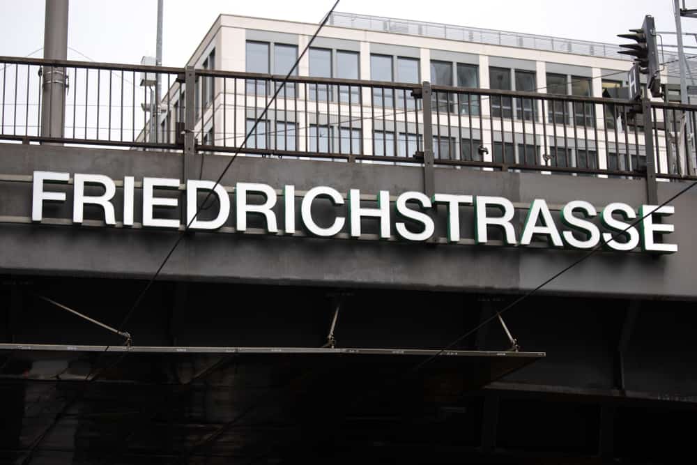 Station sign on a bridge saying: Friedrichstraße.