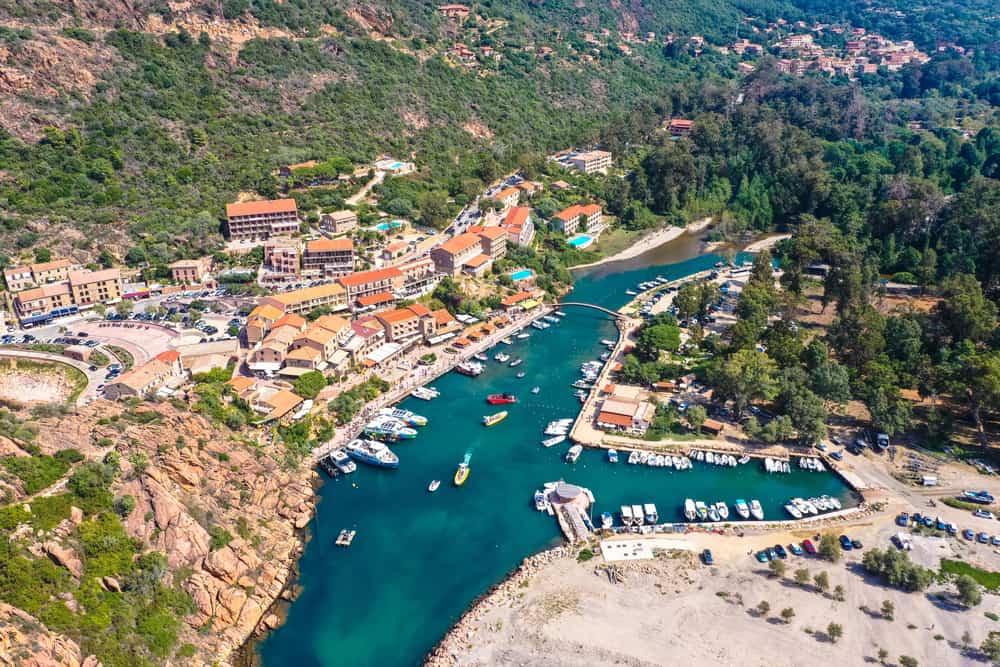 Aerial view of the town, harbor, and beach of Porto in Corsica, France.