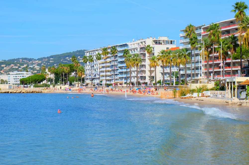 Panoramic view of Juan-les-Pins in the French Riviera. Blue ocean and hotel buildings.