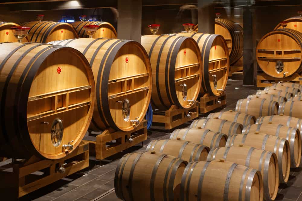 A cellar filled with oak barrels of champagne.